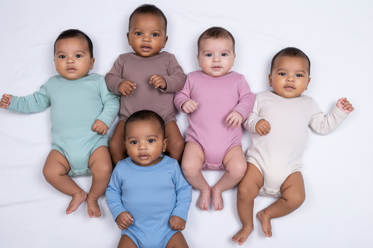 Five babies in colorful onesies on a white background