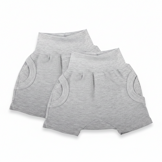 Two pairs of gray shorts on a white background