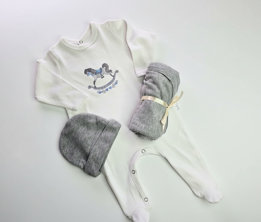 Baby outfit with white long-sleeve shirt, gray pants, and hat on a white background