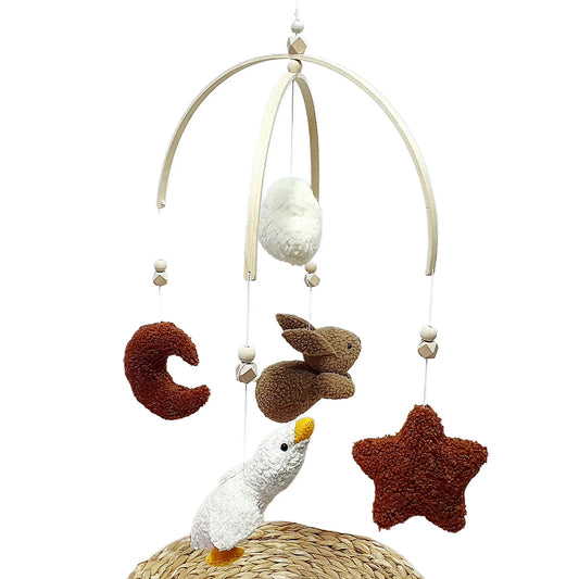 Baby mobile with hanging toys including a moon, star, and bird on a white background