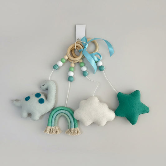 Baby mobile with dinosaur, cloud, and star toys on a textured white background