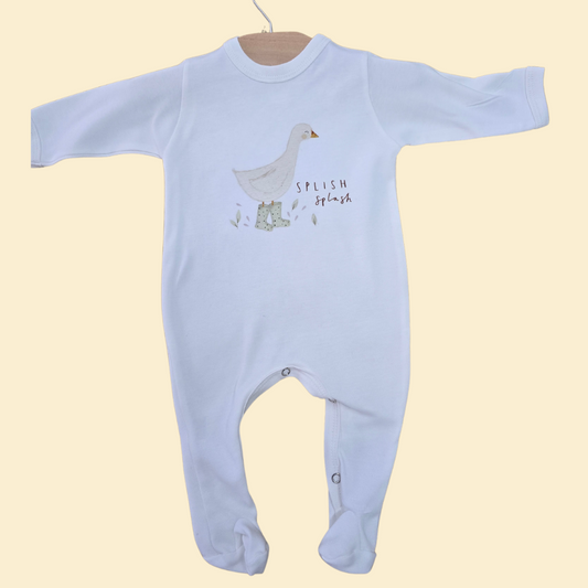 Blue baby onesie with a duck design and 'Splish Splash' text on a beige background