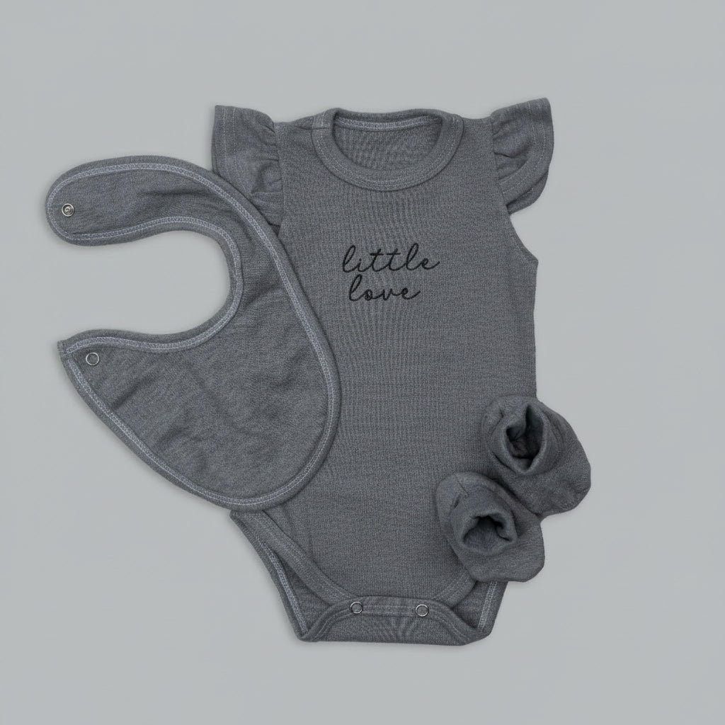 Gray baby onesie with 'little love' text and matching bib on a light gray background