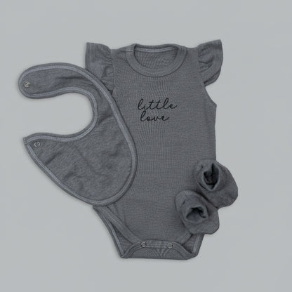 Gray baby onesie with 'little love' text and matching bib on a light gray background