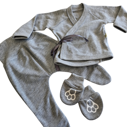 Gray baby outfit with onesie, shirt, and mittens on a white background
