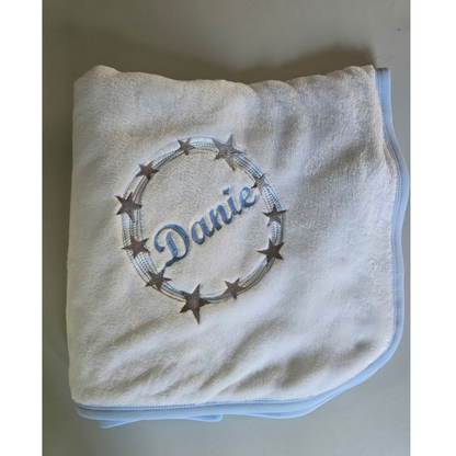 Baby blanket with 'Danie' embroidered on a plain background