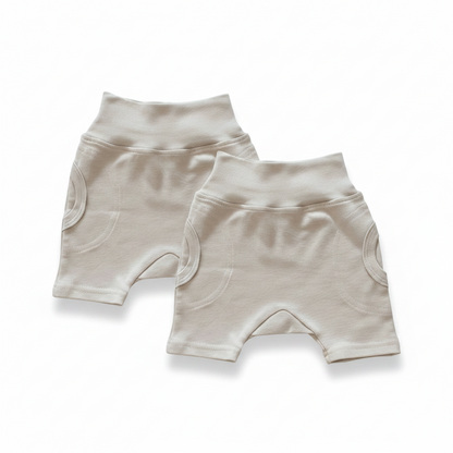 Two pairs of stone shorts on a white background