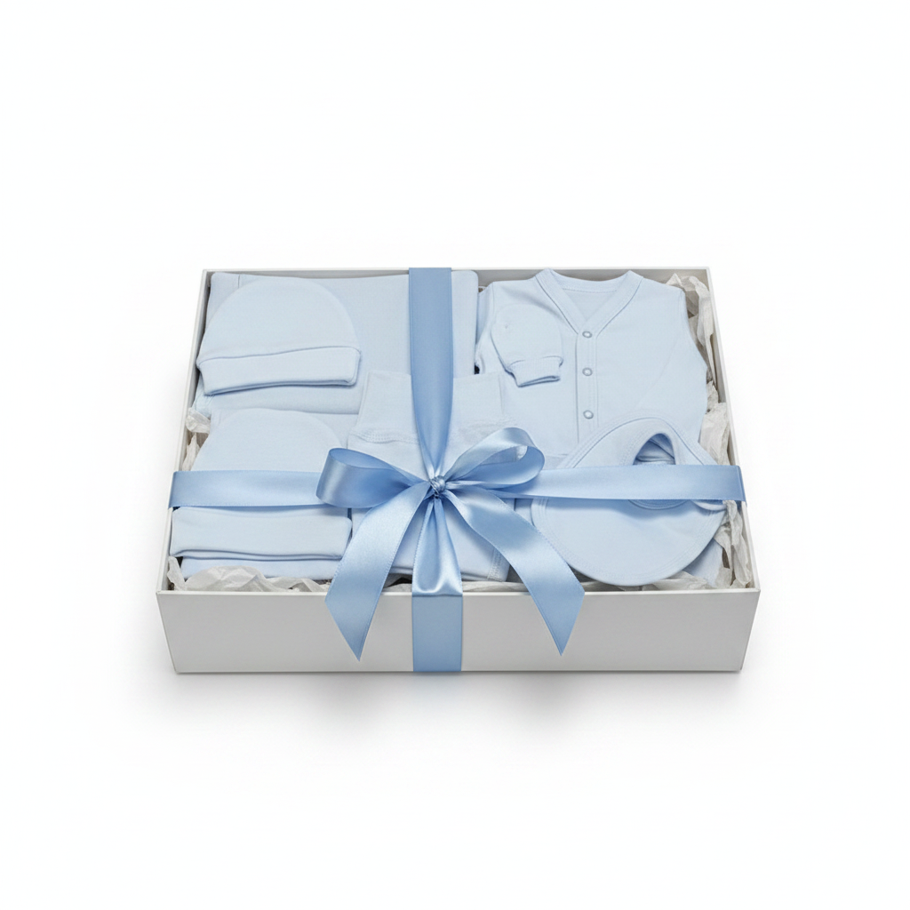 Baby gift set with blue baby clothes and a bow in a box on a white background