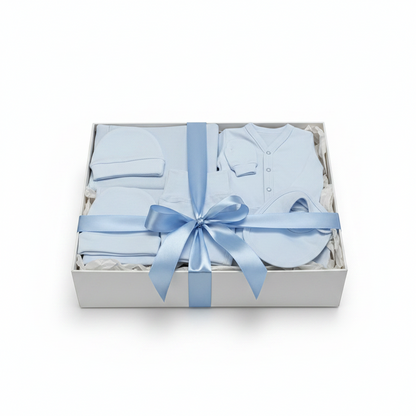 Baby gift set with blue baby clothes and a bow in a box on a white background