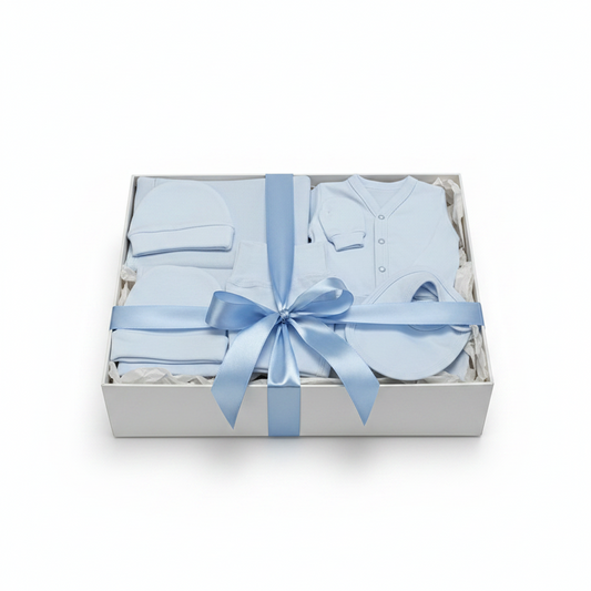 Baby gift set with blue baby clothes and a bow in a box on a white background