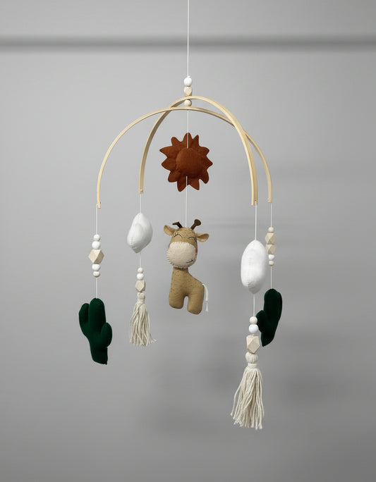 Baby mobile with hanging toys and decorations on a plain background