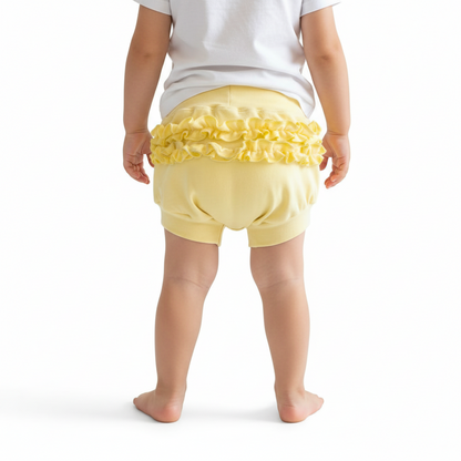 Yellow ruffled diaper cover on a white background