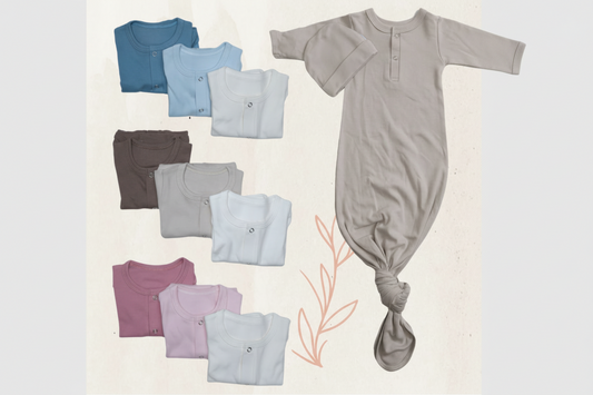 Collection of folded baby onesies in various colors with a gray baby onesie on a light background.