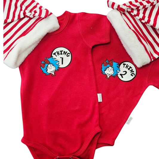 Red baby onesies with 'Thing 1' and 'Thing 2' designs on a white background