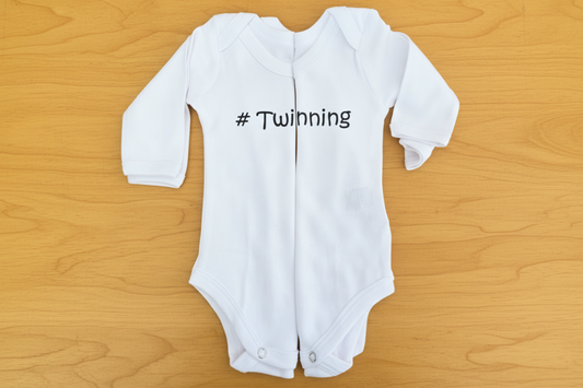 Twin Baby Gift Set of two white onesies with "#Twinning" branded over both onesies.